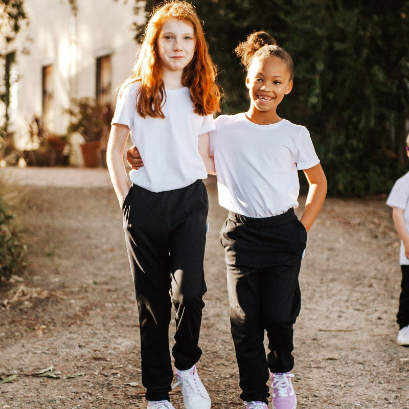 two girls walking together wearing Frankie & roy black rye pants