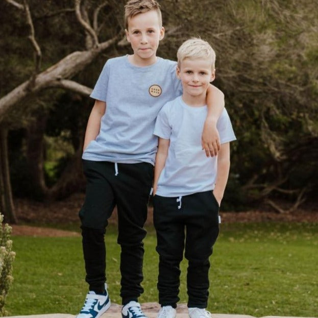 Black Skinny & Slim trackies/ joggers for boys & girls. Made in Australia our pants are designed with a smaller waist without compromising on length. Best pants for skinny kids